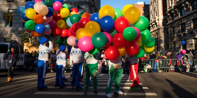 Participants take their place along the parade route before the Macy's Thanksgiving Day Parade begins in New York, Thursday, Nov. 23, 2017.
