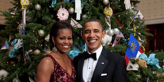 President Barack Obama and First Lady Michelle Obama pose in front of the Official White House Christmas Tree in the Blue Room of the White House, Dec. 5, 2010. (Official White House Photo by Chuck Kennedy)
This official White House photograph is being made available only for publication by news organizations and/or for personal use printing by the subject(s) of the photograph. The photograph may not be manipulated in any way and may not be used in commercial or political materials, advertisements, emails, products, promotions that in any way suggests approval or endorsement of the President, the First Family, or the White House.