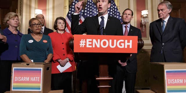 Sen. Chris Murphy, D-Conn., center, calls for gun control legislation in the wake of the mass shooting in an Orlando LGBT nightclub this week, Thursday, June 16, 2016, on Capitol Hill in Washington. From left are, Sen. Tammy Baldwin, D-Wis., Rev. Sharon Risher, Risher, a clinical trauma chaplain in Dallas, who lost her mother Ethel Lance and two cousins in the racially-motivated shooting at the historic Emanuel AME Church in Charleston, N.C. in 2015, Sen. Cory Booker, D-N.J., Sen. Dianne Feinstein, D-Calif., Murphy, Sen. Richard Blumenthal, D-Conn., and Sen. Ed Markey, D-Mass. (AP Photo/J. Scott Applewhite)