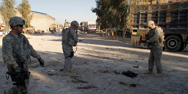 Feb. 7, 2011: U.S. soldiers inspect the scene of an explosion in Kandahar south of Kabul, Afghanistan that killed at least one person and wounded two.