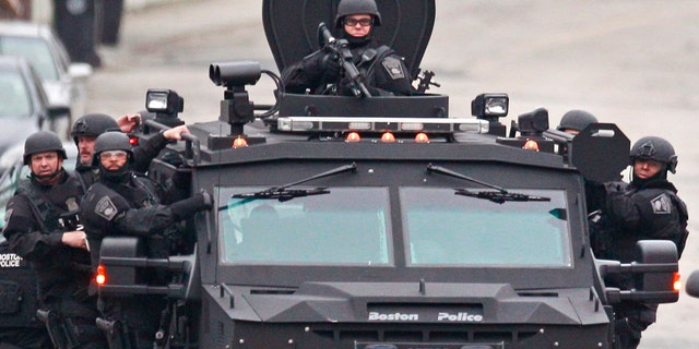 Police patrolling through a neighborhood in Watertown, Mass., while searching for a suspect in the Boston Marathon bombings in April 2013.