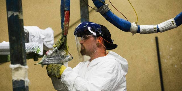 FILE - In this Aug. 7, 2014 photo, a worker assembles construction supplies at Northeast Building Products in Philadelphia. The Commerce Department releases factory orders for July on Wednesday, Sept. 2, 2015. (AP Photo/Matt Rourke, File)