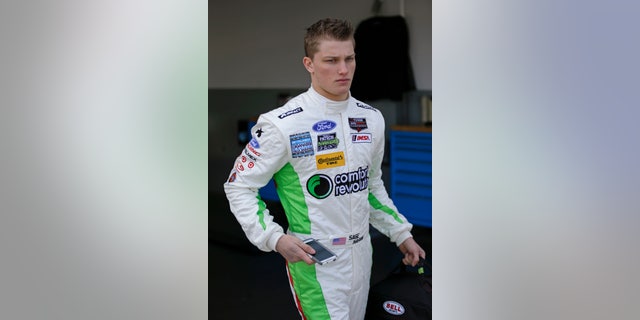 Driver Sage Karam leaves his garage after a practice session for the IMSA Series Rolex 24 hour auto race at Daytona International Speedway in Daytona Beach, Fla., Thursday, Jan. 23, 2014.(AP Photo/John Raoux)