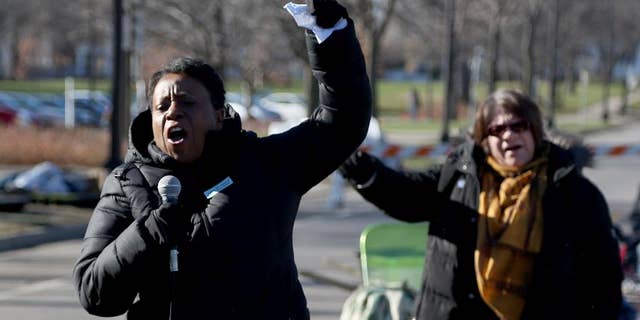 Grace Jones, of the AFSCME union, chants along with the crowd of union workers and protesters before speaking in front of a police precinct Saturday, Nov. 21, 2015, in Minneapolis. An encampment of protesters outside a Minneapolis police station vowed Saturday to maintain their vigil over the death of a black man who was shot by police, saying they won't move until video recordings of the encounter are released and authorities change how they interact with communities they serve. (Kyndell Harkness/Star Tribune via AP) MANDATORY CREDIT; ST. PAUL PIONEER PRESS OUT; MAGS OUT; TWIN CITIES LOCAL TELEVISION OUT