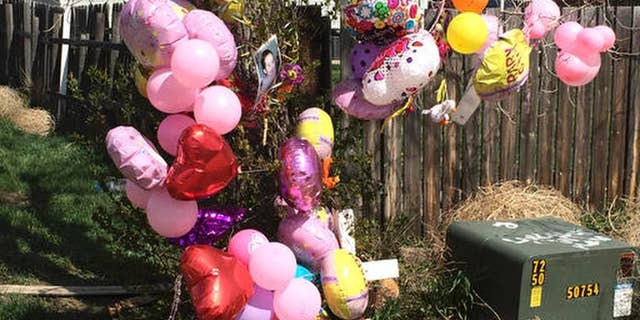 FILE - In This April 22, 2016 file photo a memorial is placed in front of the house for Kenzley Olson in Poplar, Mont. Federal prosecutors say Janelle Red Dog of Poplar, abused Olson, a 13-month-old girl in her care, and used methamphetamine while Olson was unconscious and, when she stopped breathing, put her body in a bag and threw it in a trash can before going home to sleep. Red Dog is scheduled to plead guilty on May 1, 2017 to second-degree murder. (AP Photo/Richard Peterson, File)