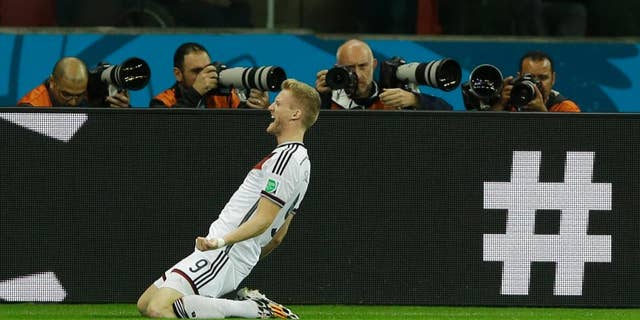 Germany's Andre Schuerrle celebrates after scoring his side's first goal in overtime during the World Cup round of 16 soccer match between Germany and Algeria at the Estadio Beira-Rio in Porto Alegre, Brazil, Monday, June 30, 2014. (AP Photo/Kirsty Wigglesworth)