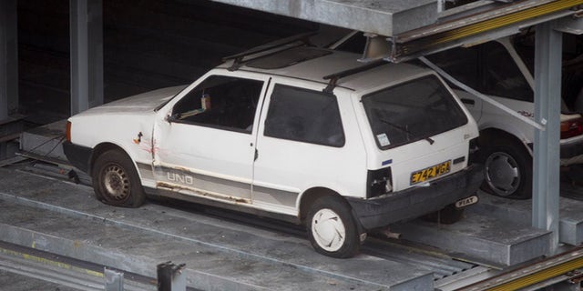 The cars are located on high floors and can be seen from adjacent buildings.