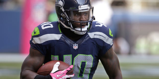 In this Oct. 13, 2013, photo, Seattle Seahawks' Derrick Coleman carries the ball against the Tennessee Titans during an NFL football game in Seattle. Coleman never listened to all those people telling him what he couldn't do. He couldn't hear them, anyway, on his way to becoming first deaf offensive player in the NFL. (AP Photo/Elaine Thompson)