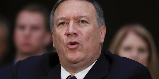 CIA Director-designate Rep. Michael Pompeo, R-Kan. testifies on Capitol Hill in Washington, Thursday, Jan. 12, 2017, at his confirmation hearing before the Senate Intelligence Committee. Seated behind Pompeo is his wife Susan Pompeo, right, and their son Nick, left. (AP Photo/Manuel Balce Ceneta)