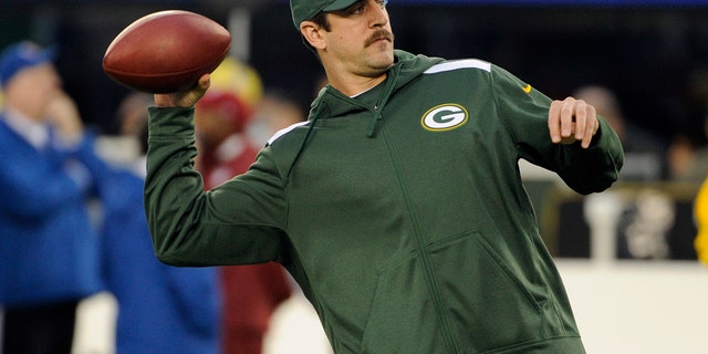 Green Bay Packers quarterback Aaron Rodgers throws a pass as his team warms up before an NFL football game against the New York Giants, Sunday, Nov. 17, 2013, in East Rutherford, N.J. (AP Photo/Bill Kostroun)