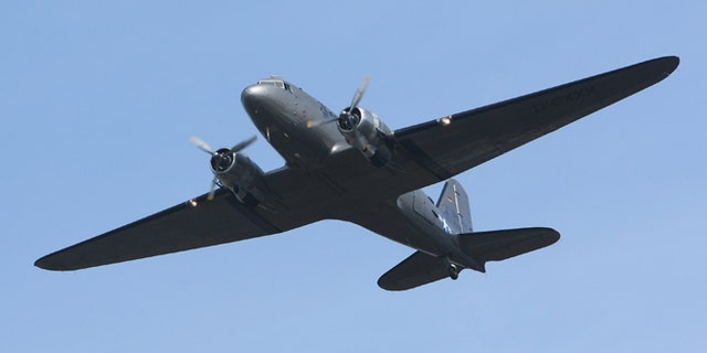 BERLIN - SEPTEMBER 02: A historic DC-3 airplane, also known as the Rosinenbomber, or Raisin Bomber, flies near Tempelhof Airport September 2, 2008 in Berlin, Germany. The Rosinenbomber flies tourists over Berlin and commemorates the Allied bombers that hauled supplies to Berlin during the Berlin Airlift in 1948, when the Soviet military blockaded the city. The Rosinenbomber flights from Temepelhof will end on October 30, 2008, on the last day of operation of Tempelhof. The airport, located in the city center, will close after approximately 70 years of operation. (Photo by Sean Gallup/Getty Images)