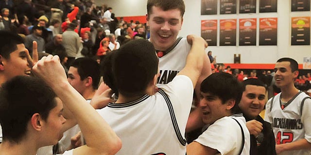 March 3, 2011: Members of the Fennville High School basketball team lift Wes Leonard, top, after he made a game-winning layup in overtime against Bridgman, in Fennville, Mich.