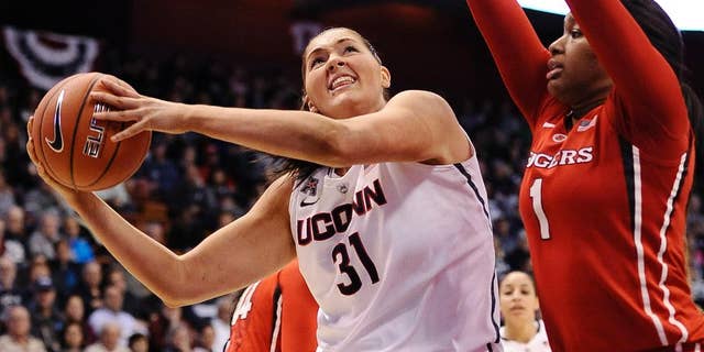 Connecticut's Stefanie Dolson (3) looks to shoot as Rutgers Rachel Hollivay, right, defends during the second half of an NCAA college basketball game in the semifinals of the American Athletic Conference women's tournament on Sunday, March 9, 2014, in Uncasville, Conn. Connecticut won 83-57. (AP Photo/Jessica Hill)