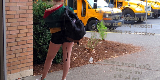 In this Sept. 7, 2018 photo, a student at Grant High School in Portland, Ore., waits for a ride after school.