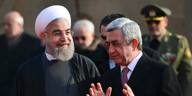 Armenian President Serzh Sargsyan, right, gestures while speaking to Iranian President Hassan Rouhani, during an official welcome ceremony at the Presidential Palace in Yerevan, Armenia, Wednesday, Dec. 21, 2016. Rouhani began his 3-day tour to Armenia, Kazakhstan and Kyrgyzstan on bilateral ties and regional developments. (Davit Hakobyan, PAN Photo via AP)