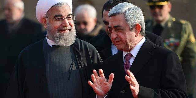Armenian President Serzh Sargsyan, right, gestures while speaking to Iranian President Hassan Rouhani, during an official welcome ceremony at the Presidential Palace in Yerevan, Armenia, Wednesday, Dec. 21, 2016. Rouhani began his 3-day tour to Armenia, Kazakhstan and Kyrgyzstan on bilateral ties and regional developments. (Davit Hakobyan, PAN Photo via AP)