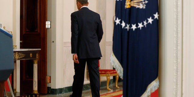 President Barack Obama leaves after speaking during a nationally televised address from the White House in Washington, Thursday, Nov. 20, 2014. Spurning furious Republicans, President Barack Obama unveiled expansive executive actions on immigration Thursday night to spare nearly 5 million people in the U.S. illegally from deportation and refocus enforcement efforts on "felons, not families." (AP Photo/Jim Bourg, Pool)