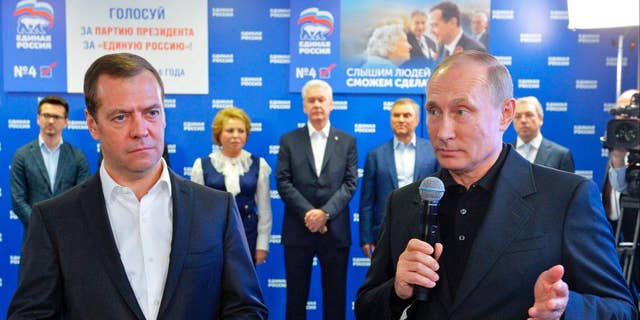 Russian President Vladimir Putin, right, and Russian Prime Minister Dmitry Medvedev, left, on Sunday.