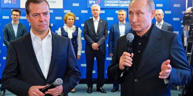 Russian President Vladimir Putin, right, and Russian Prime Minister Dmitry Medvedev, left, on Sunday.