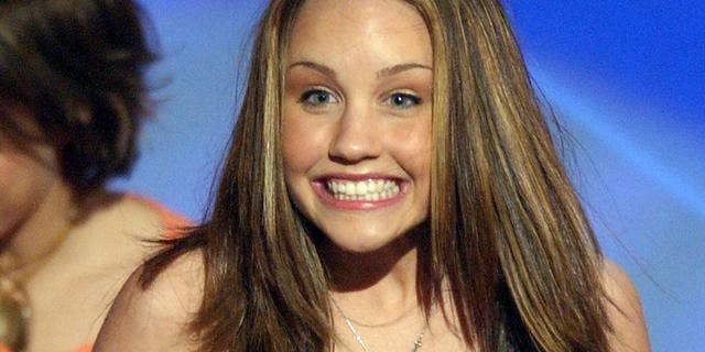 Amanda Bynes smiles on stage in 2002.