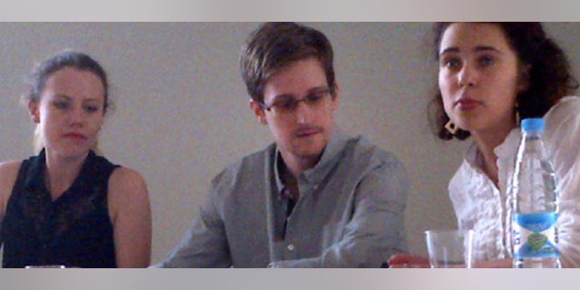 NSA leaker Edward Snowden attends a news conference at Moscow's Sheremetyevo Airport with Sarah Harrison of WikiLeaks, left, Friday, July 12, 2013.