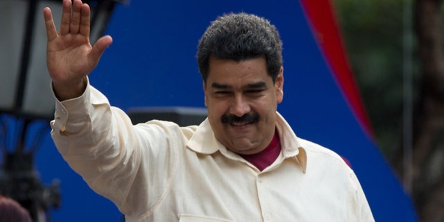 File-This April 19, 2016, file photo shows Venezuelaâs President Nicolas Maduro greeting supporters upon his arrival to Bolivar Square to celebrate the 206th anniversary of the call for independence from Spain, in Caracas, Venezuela. The president is ordering a 30 percent increase in the minimum wage, the latest move by the socialist government to grapple with high inflation and economic stagnation. The boost announced Saturday, April 30, 2016, by Maduro comes after a 25 percent increase on March 1. (AP Photo/Fernando Llano, File)
