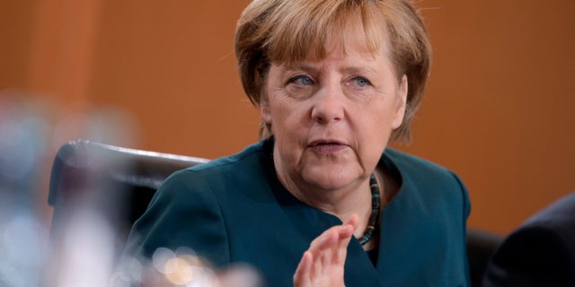 German Chancellor Angela Merkel gestures at the beginning of the weekly cabinet meeting at the chancellery in Berlin, Germany, Wednesday, Jan. 15, 2014. (AP Photo/Michael Sohn)