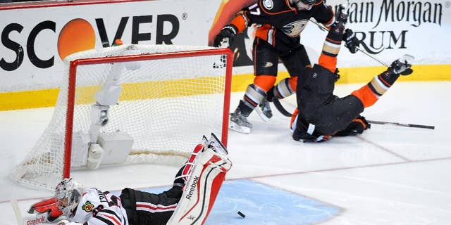 Anaheim Ducks left wing Matt Beleskey right, celebrates with Ryan Kesler after scoring the game winning goal past Chicago Blackhawks goalie Corey Crawford, left, during overtime in Game 5 of the Western Conference final of the NHL hockey Stanley Cup playoffs in Anaheim, Calif., on Monday, May 25, 2015. (AP Photo/Mark J. Terrill)