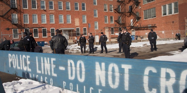 CHICAGO, IL - FEBRUARY 28: Police stand guard as demonstrators protest outside a Chicago Police facility on the city's Westside on February 28, 2015 in Chicago, Illinois. The demonstrators were demanding changes after a British newspaper article recently claimed the facility was used by Chicago police as a 'secret interrogation facility.' (Photo by Scott Olson/Getty Images)