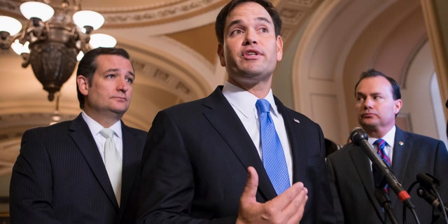 Sen. Marco Rubio, R-Fla., center, accompanied by Sen. Ted Cruz, R-Texas, left, and Sen. Mike Lee, R-Utah.