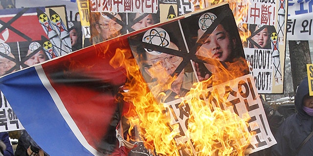Dec. 28: Anti-North Korea protesters burn a North Korea flag and pictures of North Korean leader Kim Jong Il and his youngest son Kim Jong Un during a rally in Seoul, South Korea.