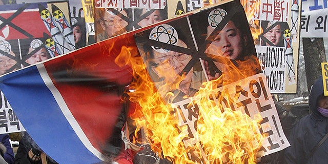 Dec. 28: Anti-North Korea protesters burn a North Korea flag and pictures of North Korean leader Kim Jong Il and his youngest son Kim Jong Un during a rally in Seoul, South Korea.