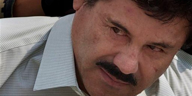 Joaquin "El Chapo" Guzman is escorted to a helicopter in handcuffs by Mexican navy marines at a navy hanger in Mexico City, Saturday, Feb. 22, 2014. A senior U.S. law enforcement official said Saturday, that Guzman, the head of Mexico's Sinaloa Cartel, was captured alive overnight in the beach resort town of Mazatlan. Guzman faces multiple federal drug trafficking indictments in the U.S. and is on the Drug Enforcement AdministrationÃs most-wanted list. (AP Photo/Eduardo Verdugo)