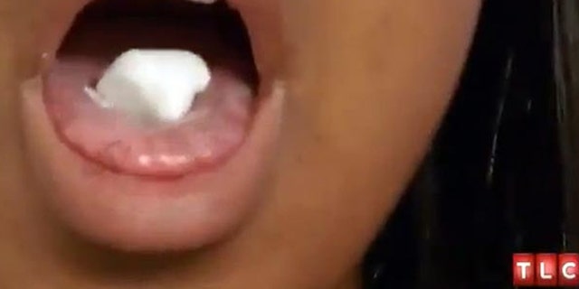 Nicole eats a piece of deodorant. Courtesy of TLC