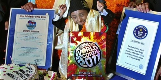 Oct. 14: Nepal's Khagendra Thapa Magar celebrates after being awarded the title of the world's shortest man by Guinness record officials, in Pokhara, 124 miles west of Katmandu, Nepal.