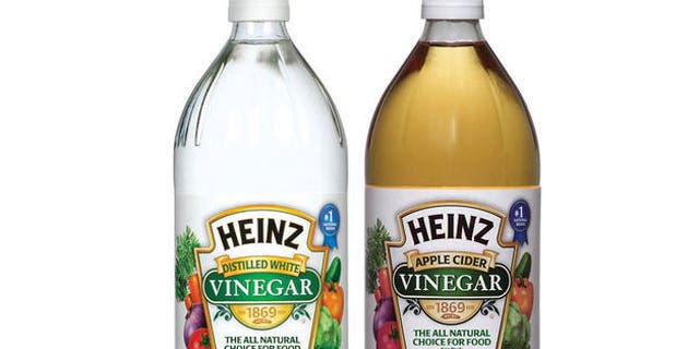 Two bottles of Heinz Vinegar. 