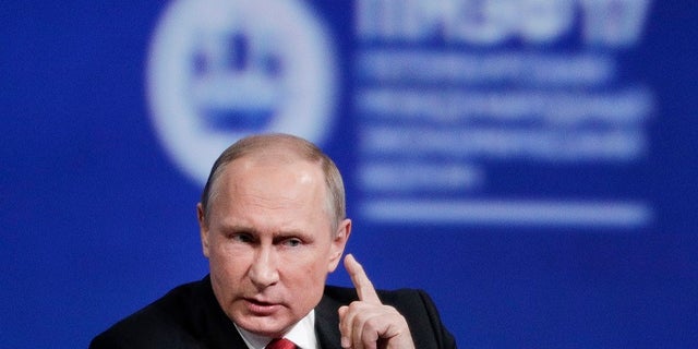 Russian President Vladimir Putin gestures as he speaks at the St. Petersburg International Economic Forum in St.Petersburg, Russia, Friday, June 2, 2017. Putin says chemical attack in Syria was provocation to frame Assad. (AP Photo/Dmitry Lovetsky)
