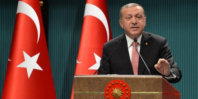 FILE - This is a Wednesday, July 20, 2016 file photo of Turkey's President Recep Tayyip Erdogan as he speaks after an emergency meeting of the government in Ankara, Turkey. Erdogan hinted on Thursday Sept. 29, 2016 that the three-month state of emergency declared following the failed July 15 coup could be extended to over a year, a day after the national security council recommended it be extended for another three months. (AP Photo/File)