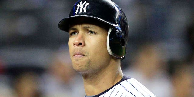 New York Yankees' Alex Rodriguez walks back to the dugout after taking a called third strike from Texas Rangers starting pitcher Cliff Lee in the second inning of Game 3 of baseball's American League Championship Series Monday, Oct. 18, 2010, in New York. (AP Photo/Charles Krupa)