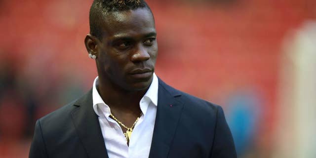 Liverpool's Mario Balotelli stands at the side of the pitch prior to the English Premier League soccer match between Liverpool and Stoke City at Anfield, Liverpool, England, Saturday Nov. 29, 2014. (AP Photo/PA, Peter Byrne) UNITED KINGDOM OUT