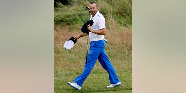 Sergio Garcia of Spain walks along the 18th fairway during the third day of the British Open Golf championship at the Royal Liverpool golf club, Hoylake, England, Saturday July 19, 2014. (AP Photo/Peter Morrison)