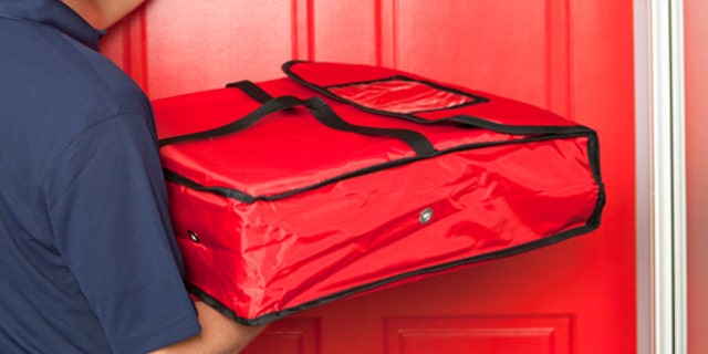 Subject: A take-out pizza delivery man delivering take-out food to customer's door.