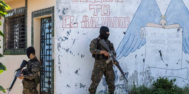 FILE - In this Aug. 31, 2015 file photo, soldiers guard a corner in a gang-controlled neighborhood in Ilopango, El Salvador. A video broadcast by local media on Saturday, March 26, 2016, purportedly made by the country’s main street gangs, is offering an end to killings, and asks the government not to continue an anti-gang offensive. Officials said they would not negotiate with the gangs. (AP Photo/Salvador Melendez, File)