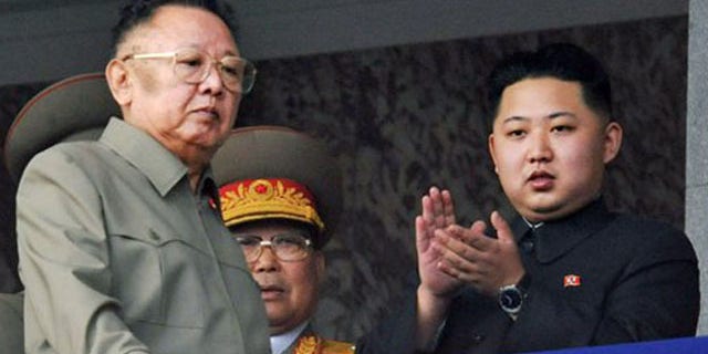 In this Oct. 10, 2010 file photo North Korea leader Kim Jong Il, left, walks by his son Kim Jong Un on the balcony as they attend a massive military parade marking the 65th anniversary of the communist nation's ruling Workers' Party in Pyongyang, North Korea.