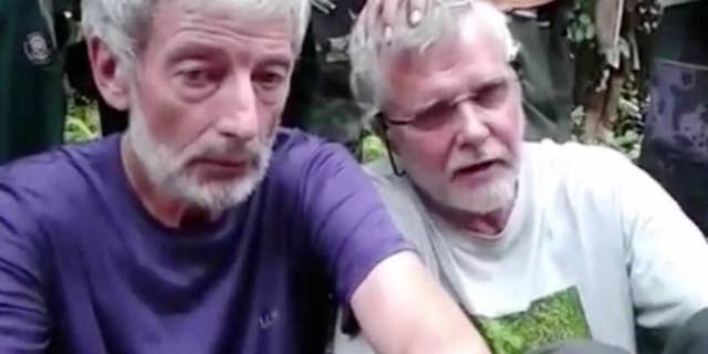 This image made from undated militant video, shows Canadians John Ridsdel, right, and Robert Hall. Canada's Prime Minister Justin Trudeau confirmed that the decapitated head of a Caucasian male recovered Monday, April 25, 2016, in the southern Philippines belongs to Ridsdel, who was taken hostage by Abu Sayyaf militants in September 2015.