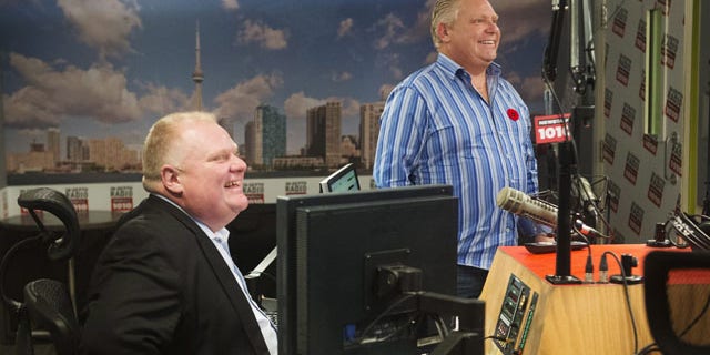 November 3, 2013: Toronto Mayor Rob Ford and his brother, Toronto city councillor Doug Ford, right, appear on a radio show in Toronto. (AP Photo/The Canadian Press, Mark Blinch)