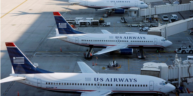 U.S. Airways aircrafts sit outside terminal 4 at Phoenix Sky Harbor International Airport in Phoenix, April 8, 2010. UAL Corp's United Airlines is in merger talks with U.S. Airways in a deal that could create the second-largest carrier in the United States, two sources familiar with the matter said. REUTERS/Joshua Lott (UNITED STATES - Tags: BUSINESS TRANSPORT)