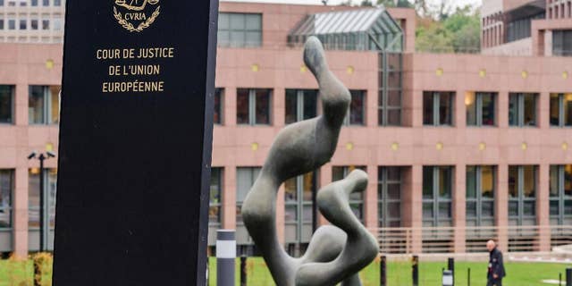 FILE - In this Oct. 5, 2015 file photo, a man walks by the European Court of Justice in Luxembourg. The European Court of Justice ruled on Tuesday, Jan. 31, 2017, that an asylum request can be rejected if the person seeking protection has links to a terrorist group. (AP Photo/Geert Vanden Wijngaert, File)