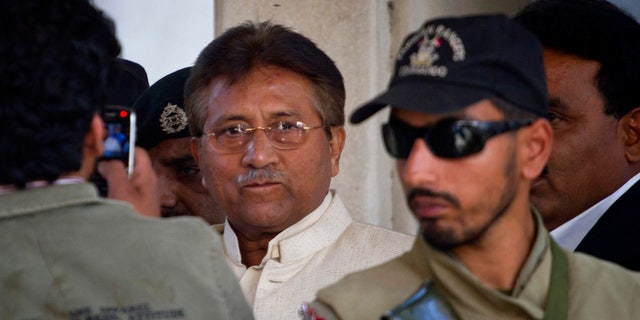 FILE -- In this Wednesday, April 17, 2013 file photo, Pakistan's former president and military ruler Pervez Musharraf, center, leaves after appearing in court in Rawalpindi, Pakistan. Pakistan's government plans to put former President Pervez Musharraf on trial for treason for declaring a state of emergency and suspending the constitution while in power, the interior minister said Sunday, Nov. 17, 2013. (AP Photo/Anjum Naveed, File)