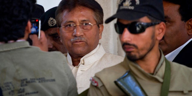 FILE -- In this Wednesday, April 17, 2013 file photo, Pakistan's former president and military ruler Pervez Musharraf, center, leaves after appearing in court in Rawalpindi, Pakistan. Pakistan's government plans to put former President Pervez Musharraf on trial for treason for declaring a state of emergency and suspending the constitution while in power, the interior minister said Sunday, Nov. 17, 2013. (AP Photo/Anjum Naveed, File)